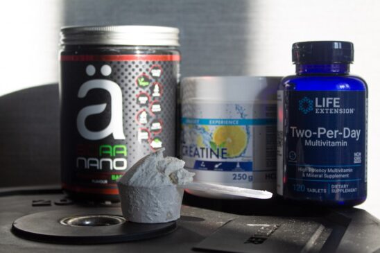 FITPULSE | Enhance Athletic Performance: Top 10 Supplements 2025 a table topped with bottles of vitamins and pills