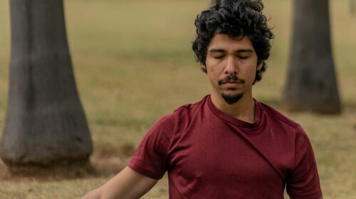 a man sitting on a mat