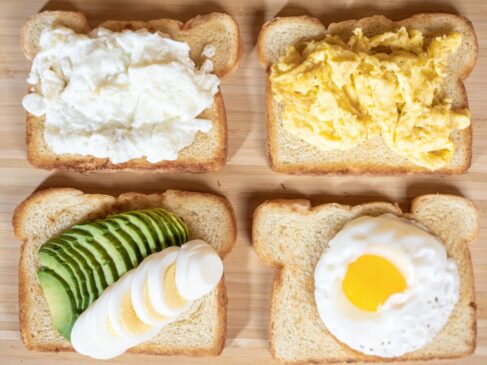 Four slices of bread with different types of food on them