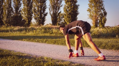 a man bending over on a road